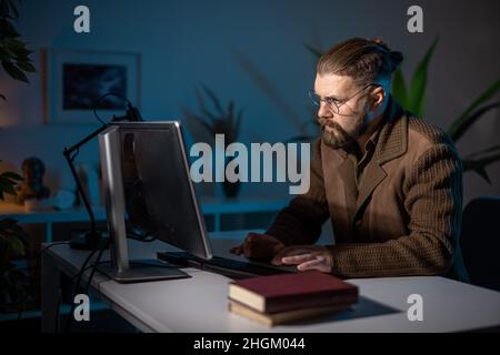 Man working late on pc Stock Photo