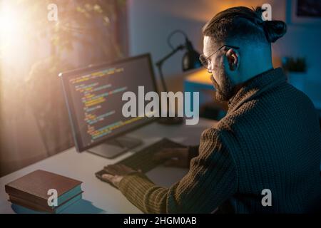 Man coding on pc Stock Photo