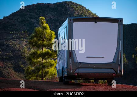 Camper van summer holiday vacation and free tourism lifestyle. Big camping car motorhome parked off road and enjoying mountains ad nature. Family tour Stock Photo