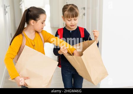 advertising, childhood, delivery, mail and people - two little girls with delivery packages Stock Photo