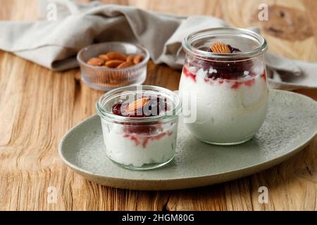 Risalamande, Danish Dessert Rice Pudding with Vanilla, Almonds,  and Whipped Cream, Served with Warm Cherry Sauce. Stock Photo