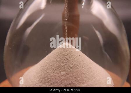 hourglass spilling sand counting killing time Stock Photo