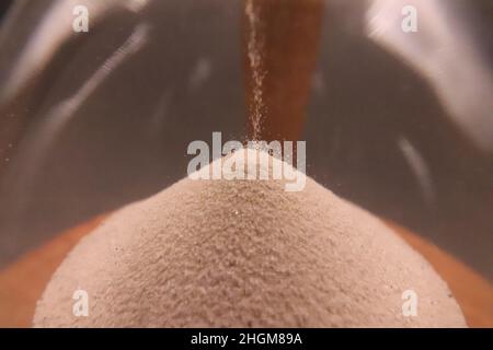 hourglass spilling sand counting killing time Stock Photo