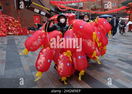 London, UK, 21st Jan, 2022. Workers in London's Chinatown take down the area's iconic red lanterns and replace with this year's versions bearing current sponsors' names, ahead of Chinese New Year on February 1st, that will see the Chinese community welcoming in the Year of the Tiger. Credit: Eleventh Hour Photography/Alamy Live News Stock Photo