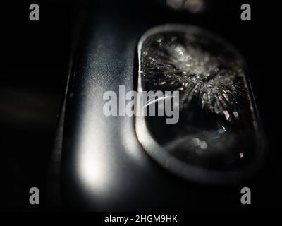 Close up shoot of broken mobile phone camera. shoot on black background Stock Photo