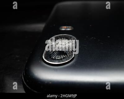 Close up shoot of broken mobile phone camera. shoot on black background Stock Photo
