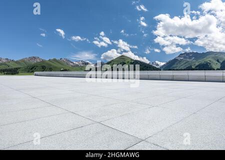 Empty square floor and mountains under blue sky Stock Photo