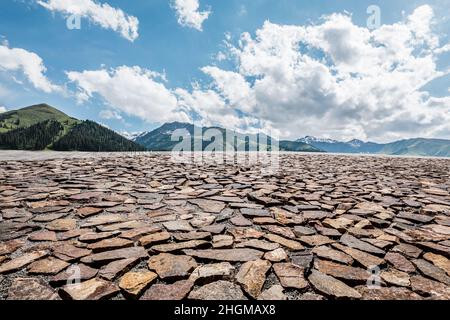 Empty square floor and mountains under blue sky Stock Photo