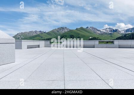 Empty square floor and mountains under blue sky Stock Photo