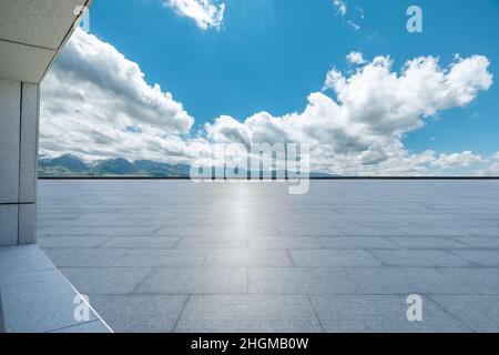 Empty square floor and mountains under blue sky Stock Photo