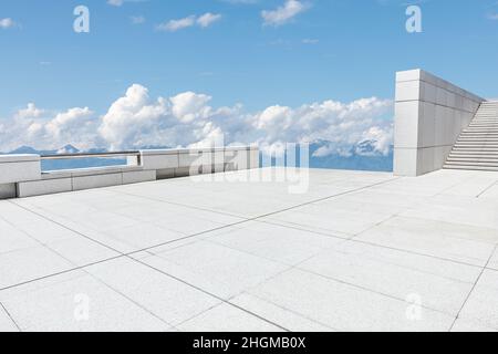 Empty square floor and mountains under blue sky Stock Photo