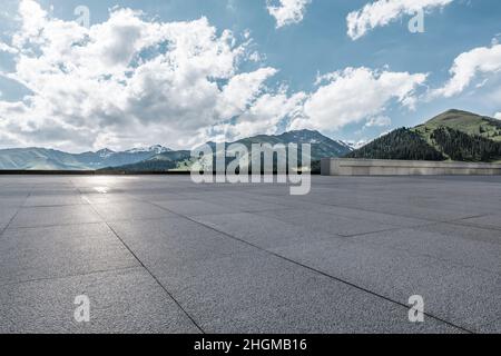 Empty square floor and mountains under blue sky Stock Photo