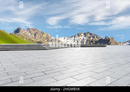 Empty square floor and mountains under blue sky Stock Photo