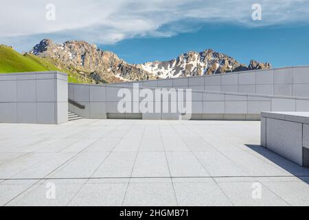 Empty square floor and mountains under blue sky Stock Photo