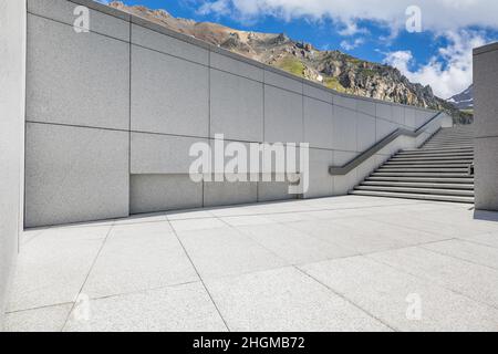 Empty square floor and mountains under blue sky Stock Photo