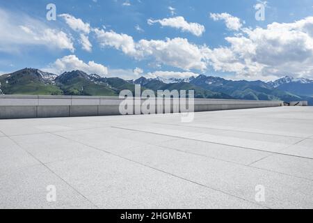 Empty square floor and mountains under blue sky Stock Photo