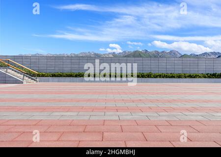 Empty square floor and mountains under blue sky Stock Photo