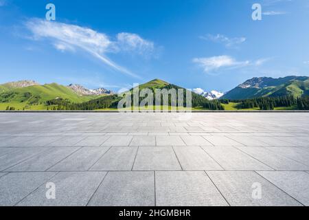 Empty square floor and mountains under blue sky Stock Photo
