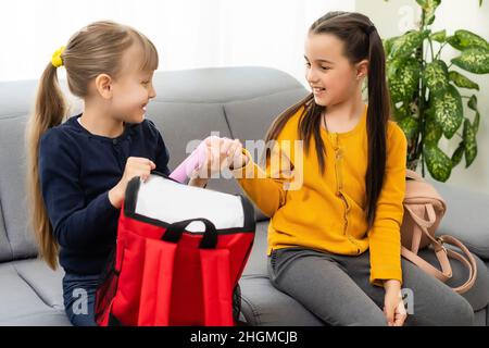 Children go back to school. Start of new school year after summer vacation. girls with backpack and books on first school day. Beginning of class Stock Photo