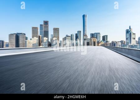 Motion blurred asphalt road and city skyline with buildings in Beijing, China. Stock Photo