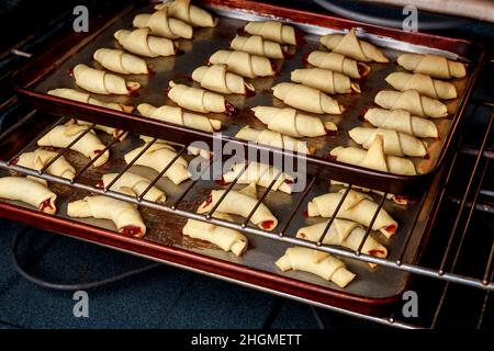 Baking homemade crescent cookies stuffed with jam. Stock Photo