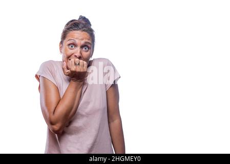 A nervous woman with her hand over her mouth Stock Photo