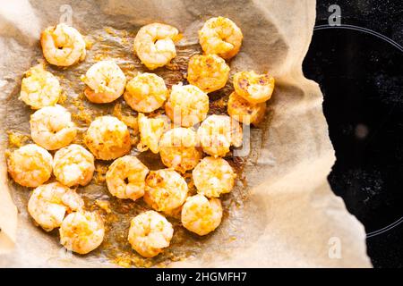 fried shrimps or prawns on parchment paper Stock Photo