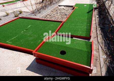 green artificial grass and rocks on miniature golf course Stock Photo