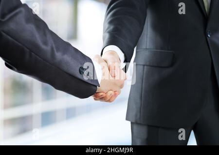 business and office concept - businessman shaking hands Stock Photo