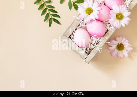 The minimum concept of Easter. Easter Eggs painted pink eggs on trendy pastel background. Top view flat lay. Stock Photo