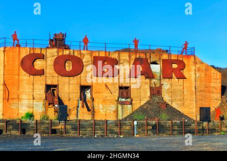 Welcome to Cobar copper mining town in Australian outback - town name plate with old historic equipment. Stock Photo