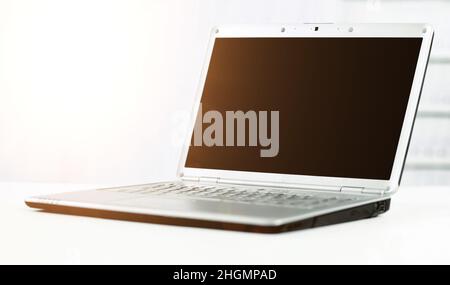 Silvery laptop at modern office Stock Photo