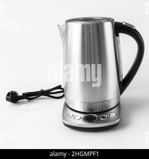 Electric kettle with stand isolated on white background. Electric cord with  plug Stock Photo - Alamy