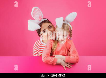 Family easter. Sister girls with bunny ears. Egg hunt. Happy childhood. Isolated. Stock Photo