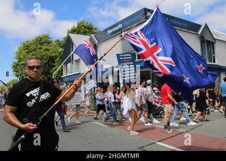 Christchurch, New Zealand. 22nd Jan, 2022. Destiny Church, Christchurch Pastor, Derek Tait is seen holding an inverted New Zealand flag during the protest. Protesters take to the streets in the affluent suburb of Merivale in protest against the mandatory Covid19 vaccination. Credit: SOPA Images Limited/Alamy Live News Stock Photo