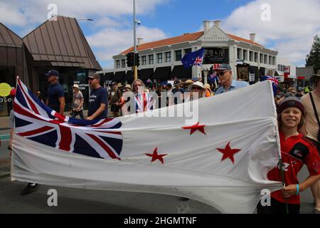 Christchurch, New Zealand. 22nd Jan, 2022. Protesters hold a New Zealand flag set upon an untraditional white background during the antivax protest in Merivale. Protesters take to the streets in the affluent suburb of Merivale in protest against the mandatory Covid19 vaccination. Credit: SOPA Images Limited/Alamy Live News Stock Photo