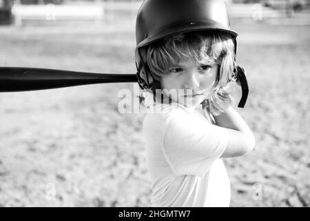 Child baseball player focused ready to bat. Kid holding a baseball bat. Stock Photo