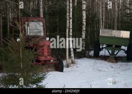 Abandoned tractor in the forest Stock Photo