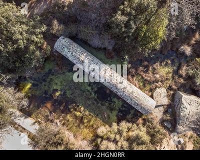 Aerial view of the Monolith of Algajola. A large granite column measuring 17.36m by 2.74m cut in 1837 to be used for a statue of Napoleon 1st but coul Stock Photo