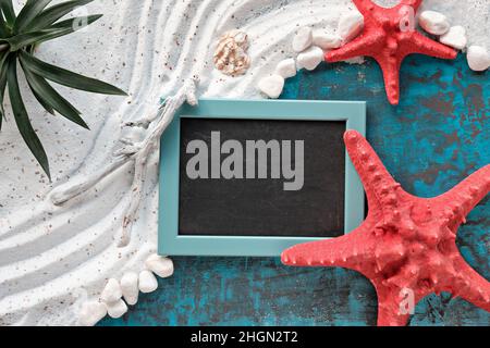 Sand and sea background with white sand on turquoise blue board, red white sea decor, exotic plant Stock Photo