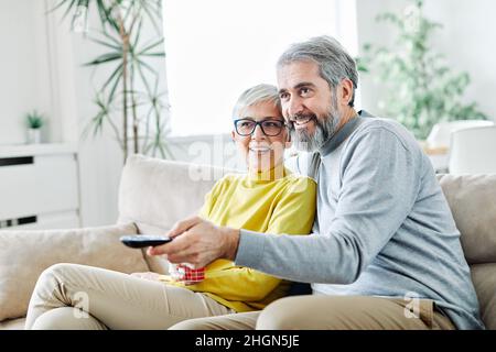 senior couple watching tv happy mature television together Stock Photo