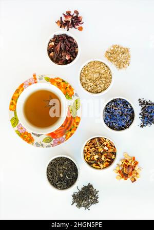 Natural herbal tea of different varieties. Variety of dry tea in utensils, close up. Stock Photo