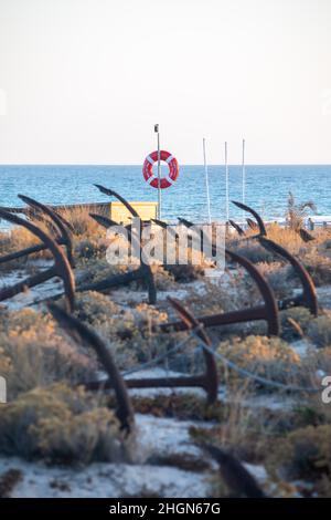 The arrangement of anchors memorial to the lost tuna fishing industry that once thrived there and were used to keep the nets in place as opposed to mo Stock Photo