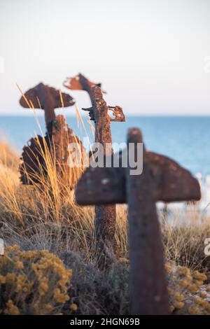 The arrangement of anchors memorial to the lost tuna fishing industry that once thrived there and were used to keep the nets in place as opposed to mo Stock Photo