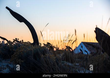 The arrangement of anchors memorial to the lost tuna fishing industry that once thrived there and were used to keep the nets in place as opposed to mo Stock Photo