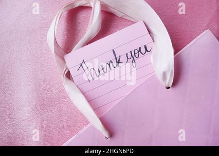 close up of thank you note on a sticky paper on pink background  Stock Photo