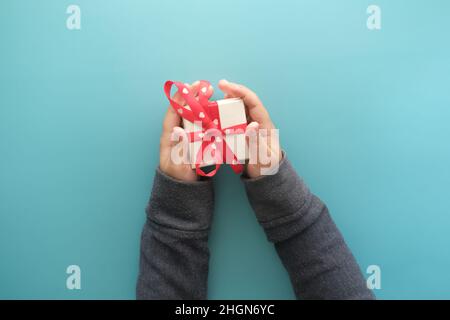 top view of child hand hold homemade gift box top view  Stock Photo