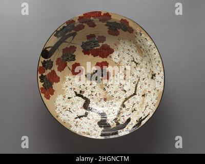 Large Bowl with Cherry Blossoms and Maple Leaves first half of the 19th century Takahashi D?hachi III The combination of cherry blossoms and colorful maple leaves on this large bowl revive the style of Kyoto’s famous ceramic artist Ogata Kenzan (1663–1743). The vivid composition is based on a poem about the Tatsuta River, from the waka anthology Kokin Wakash? (ca. 905). The poet describes fallen autumn foliage drifting on the water’s surface as if it were gold brocade, and cherry blossoms in the Yoshino hills that put him in mind of white snowflakes. The patterns evoke both symbolic images of Stock Photo