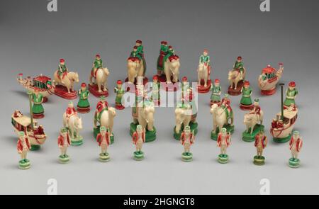 Chessmen (32) late 18th–early 19th century Indian The British have red jackets and green bases, the Indians green jackets and red bases. Both kings consist of an elephant with mahout, and a rajah with a second figure in an open howdah. The queens are similar, except that neither figure is a rajah. On the camels, as bishops, are a Hindu on the red side and a John Bull-like figure on the green. The knights are horses, and the rooks are boats, an Indian one with a pagoda-like awning and a British cutter with mast and rudder, both with small figures. The Hindu pawns hold swords and wear pleated sk Stock Photo