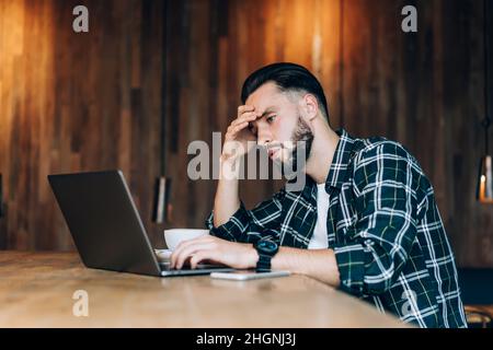 tired Caucasian graphic designer watching designed video Stock Photo